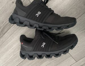 Close-up of black mesh-upper running sneakers